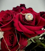 Lotus white jade pendant necklace on a red rose