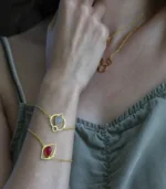 Woman wearing the Cat Eye Bracelet-Red Aventurine and Cat Eye Bracelet-Blue Topaz