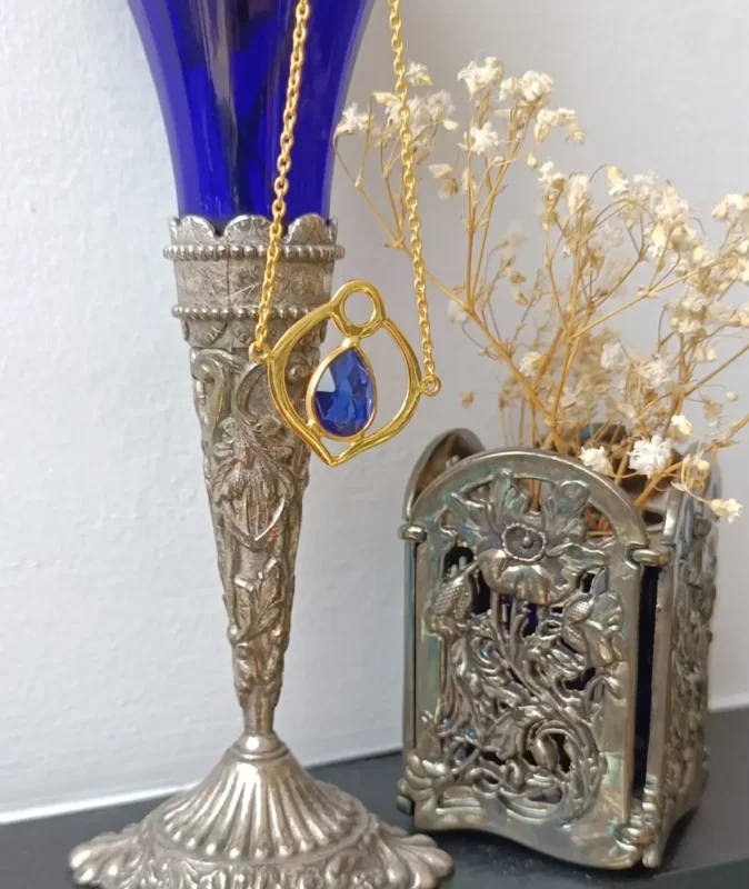 gold plated bracelet with a blue tanzanite stone